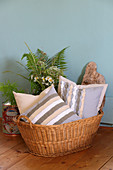 Scatter cushions with DIY covers made from strips of fabric in basket