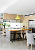 Bright, open kitchen with counter and polished concrete floor