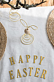 Easter greeting in gold letters on table