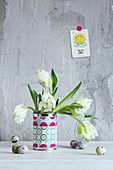 White tulips in can covered with fabric