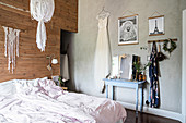 Bohemian accessories in bedroom with board wall