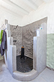 Masonry shower cubicle in rustic bathroom