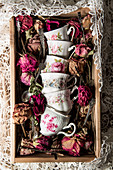 Vintage cups with floral motifs and dried flowers