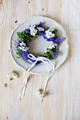 Small wreath of grape hyacinth flowers on plate