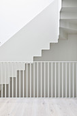 White staircase, balustrade, walls and floor