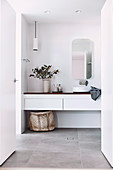 Simple modern bathroom in white with gray tiled floor