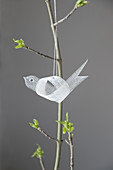 Tiny, delicate bird made from pallet band hung from spring bouquet