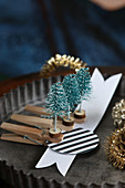Handmade miniature Christmas-tree decorations on pegs