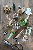 Handcrafted, paper Christmas decorations, cones of sweets, pictures of roses, scissors and glitter