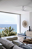 Living room in natural tones with panoramic windows to the sea