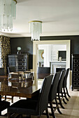 Formal dining room with black ebonised cabinets and polished table