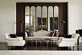 Sofa and armchairs in drawing room with gilded pier glass mirror