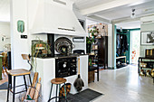 Traditional, wood-fired stove in open-plan, vintage-style interior