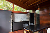 Dining table and small kitchen counter in sustainable, architect-designed house