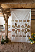 Curtain with cut-out pattern of flowers and holes in country house
