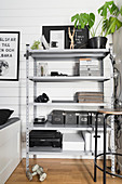 Boxes and office utensils on grey metal shelves