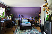Chaise chair in interior with purple walls and vintage-style decorations
