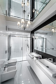 Luxurious bathroom with mirrored ceiling and glossy tiles