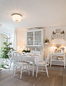 Vintage-style kitchen-dining room decorated entirely in white