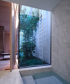 Spa area with marble-clad pool and floor-to-ceiling window