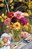 Autumn bouquet of dahlias and rose hips