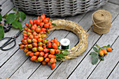 Autumn wreath with rose hips on a straw wreath