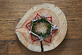 Rustic star made from nails and felt yarn and wreath on wooden board