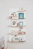 Curved wooden shelf for books and pictures in children's rooms
