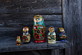 Traditional Russian dolls on wooden bench outside cabin