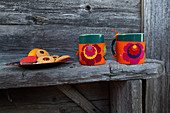 Handmade felt mug cosies with colourful floral mtifs