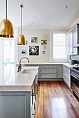 Country-house kitchen with pale blue cupboards and island counter