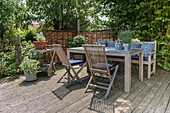 Wooden furniture on garden terrace