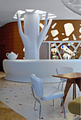 White bar and tree-like sculpture in hotel lobby