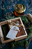 Jar of honey with tag in wooden box as Christmas present