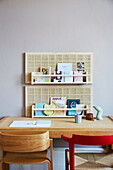 Woven panels and shelves on wall above desk