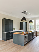 Island counter in elegant kitchen with grey furnishings