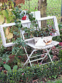 Window frame on old folding chair in autumnal garden