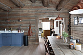 Rustic dining table in kitchen-dining room of log cabin