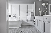 Luxurious bathroom in white and grey with coffered wall and pattern tiles