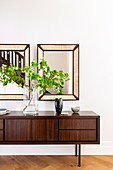 Two mirrors above the sideboard in Mid Century style in dark wood
