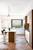 Modern open kitchen with kitchen island and herringbone parquet flooring