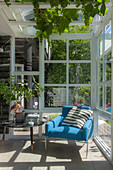 Blue armchair and coffee table in conservatory