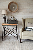 Rustic ornaments on side table next to armchair