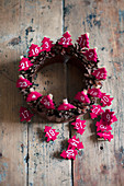 Wreath of pine cones with numbered, red felt Christmas trees