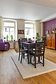 Dark dining set in interior with purple accents
