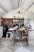 Dining table in rustic kitchen with chequered floor