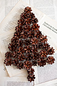 Christmas-tree shape made from pine cones on book pages