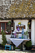 Vintage outdoor kitchen on exterior wall of old half-timbered house with thatched roof