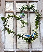 Heart wreath with evergreen branches and bird figures