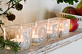 Lanterns with inscription 'NOEL' made with paper cut letters